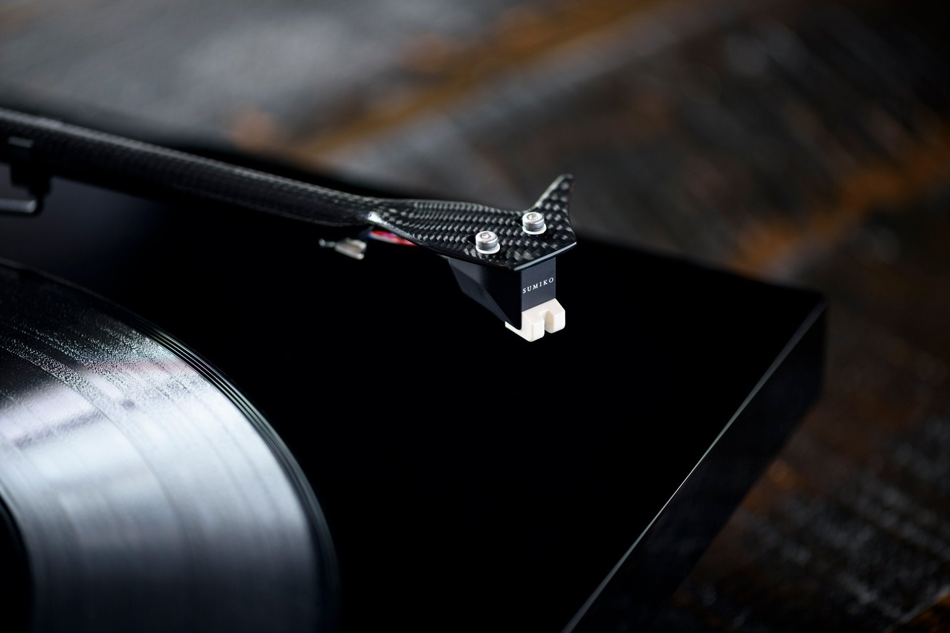 Sumiko Rainier MM phono cartridge mounted on a turntable, showcasing the cartridge's stylus and body for high-quality vinyl playback.