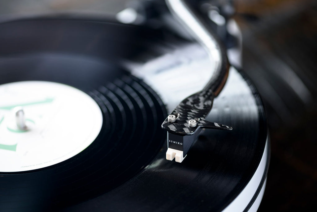 Sumiko Rainier MM phono cartridge mounted on a turntable, showcasing the sleek design and stylus tip for high-quality vinyl playback.