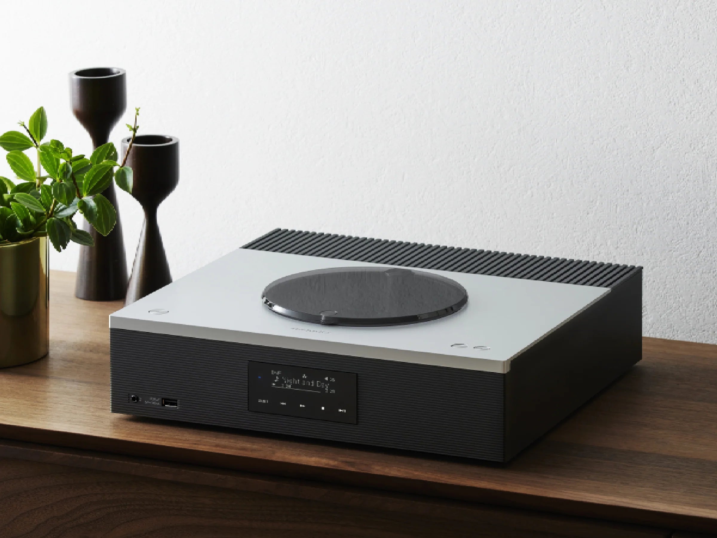 Technics SA-C600 stereo amplifier shown in a modern living room setup with sleek design and digital controls.
