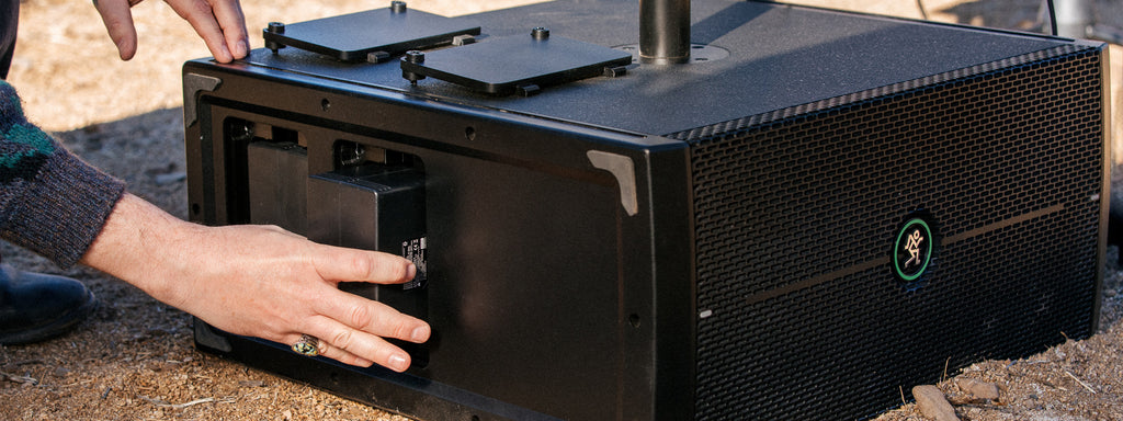 Mackie ThumpSub GO compact portable subwoofer with rugged black enclosure and control panel, designed for powerful bass.
