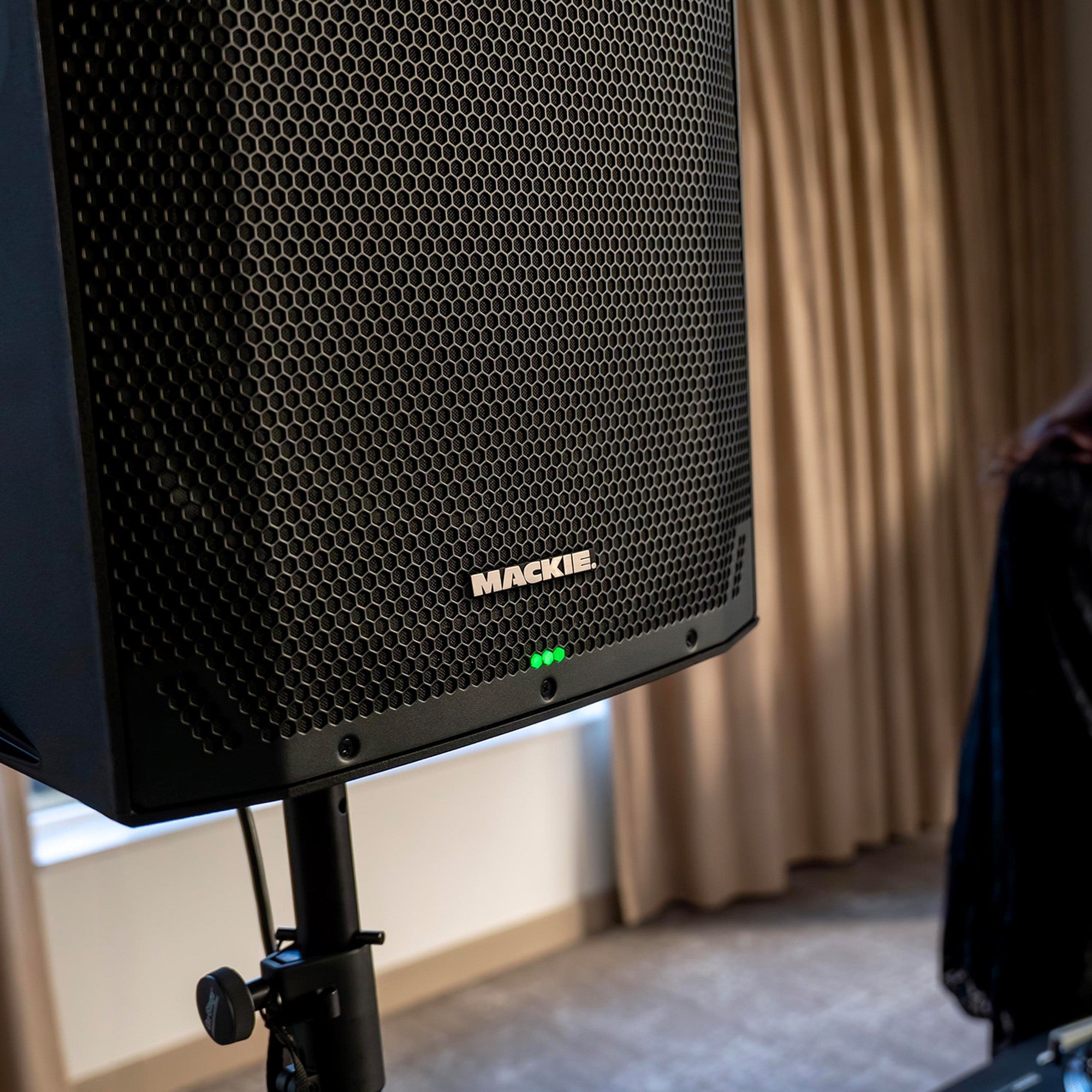 Mackie Thump15v4 active loudspeaker with large speaker cone and control panel, designed for live sound and DJ setups.