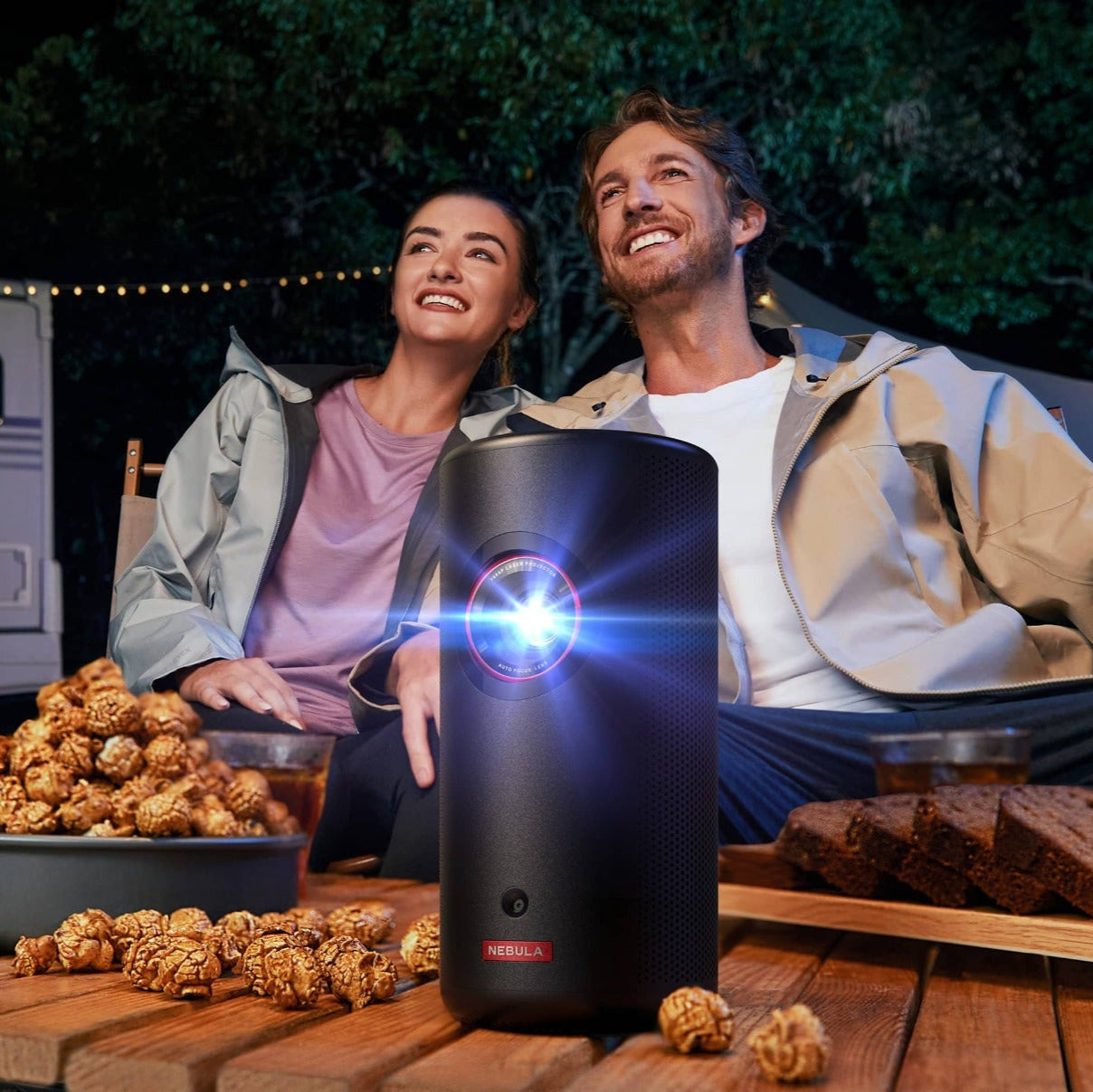 Nebula Capsule 3 Laser projector showing a vibrant image projected onto a wall with sleek black design and compact size.