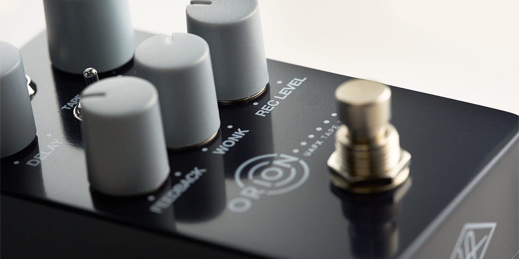 Universal Audio UAFX Orion Tape Echo effects pedal with vintage tape echo design and controls in a close-up image.