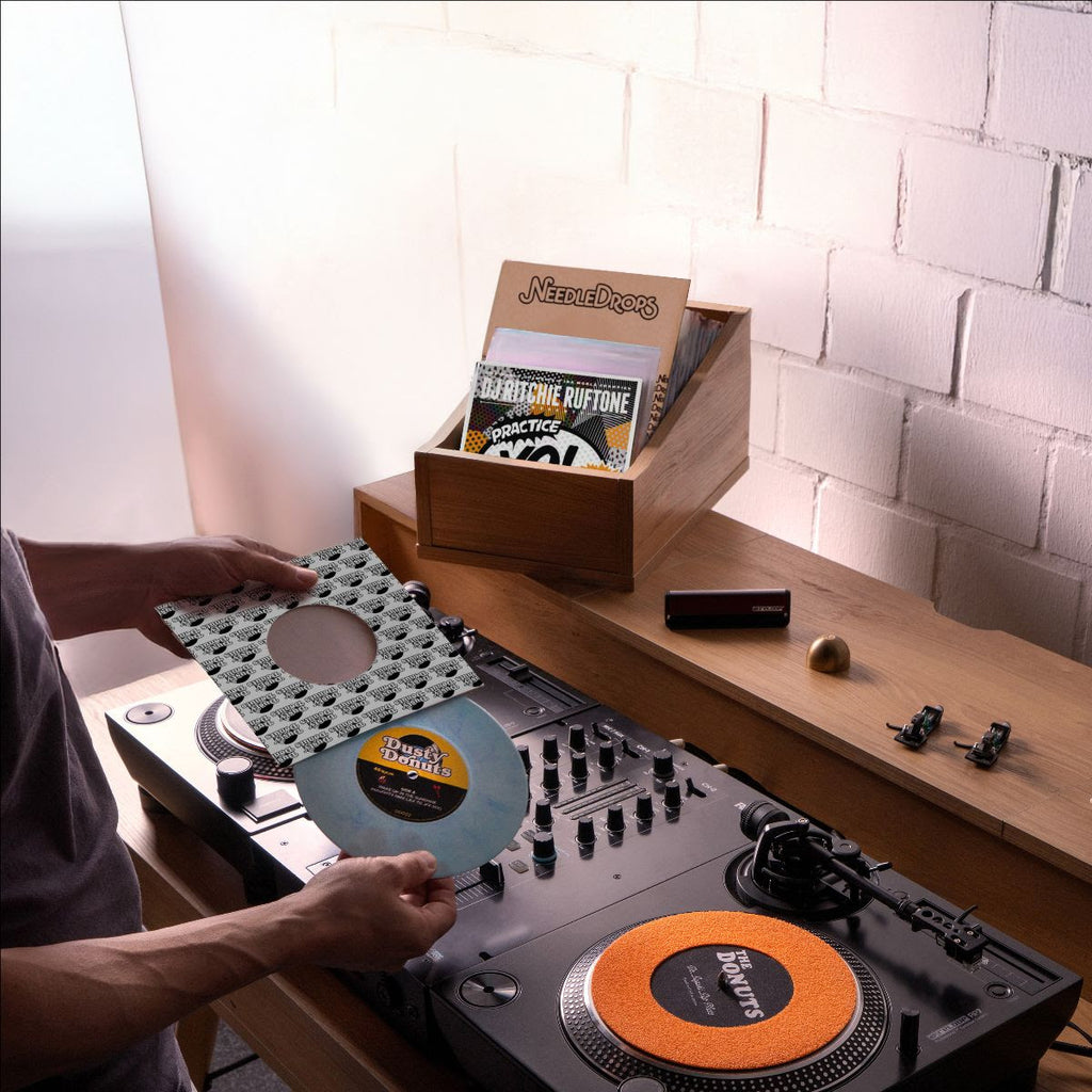 Reloop RP-7 DJ turntable with a sleek black platter, tonearm, and control knobs, designed for professional DJ setups.