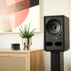 Vestlyd M6C Active in Black on a floor stand next to a sideboard in a living room