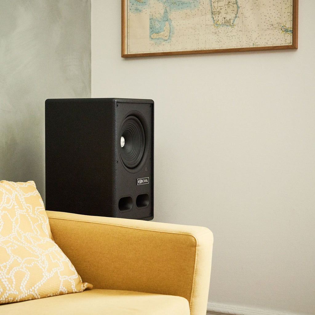 Vestlyd M8C Active in Black on a floor stand beside a yellow armchair