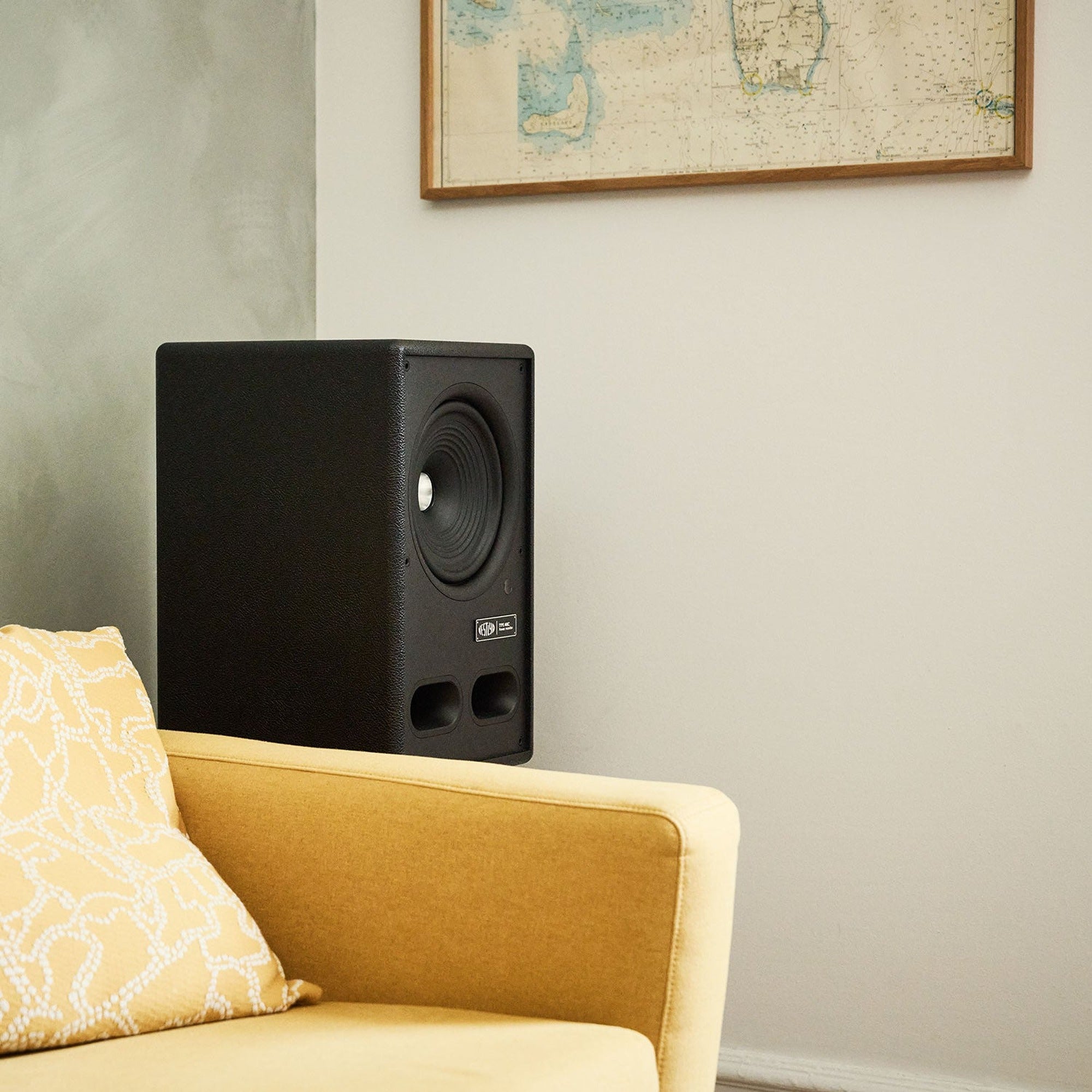 Vestlyd M8C Active in Black on a floor stand beside a yellow armchair