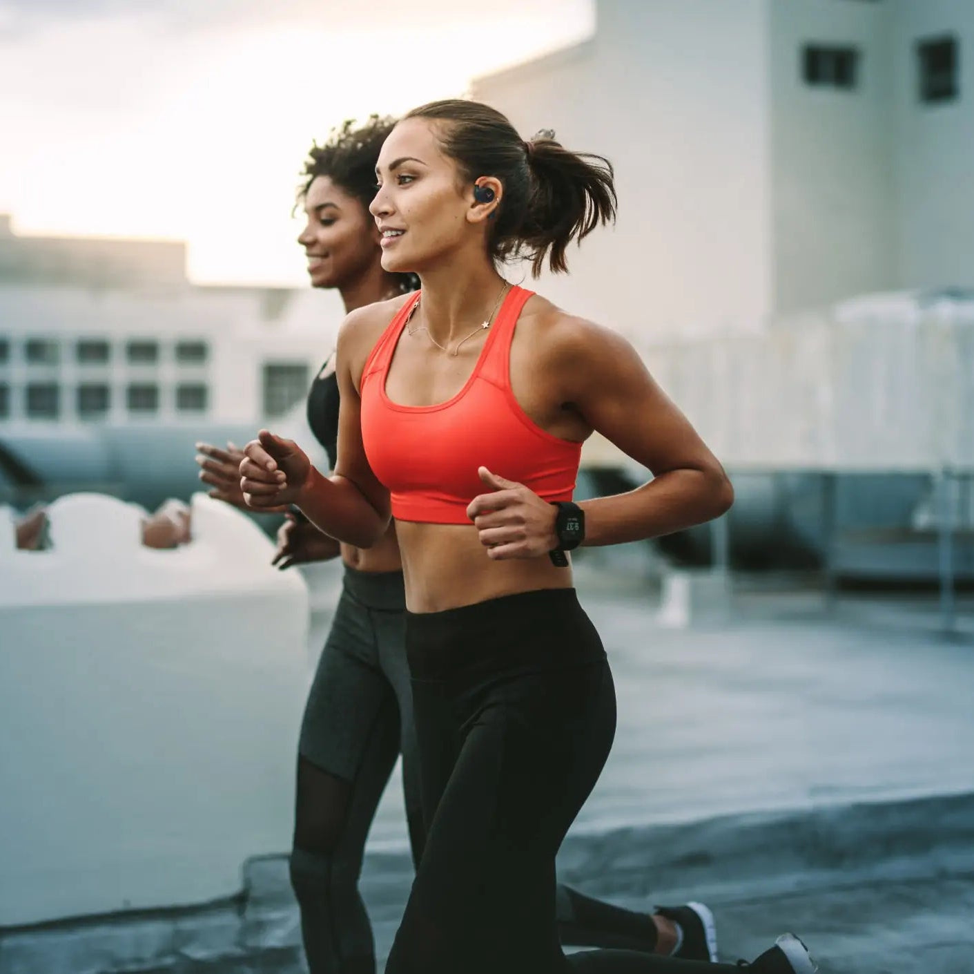 Beyerdynamic Verio 200 wireless in-ear headphones worn by a woman running, showcasing their sporty and comfortable design.