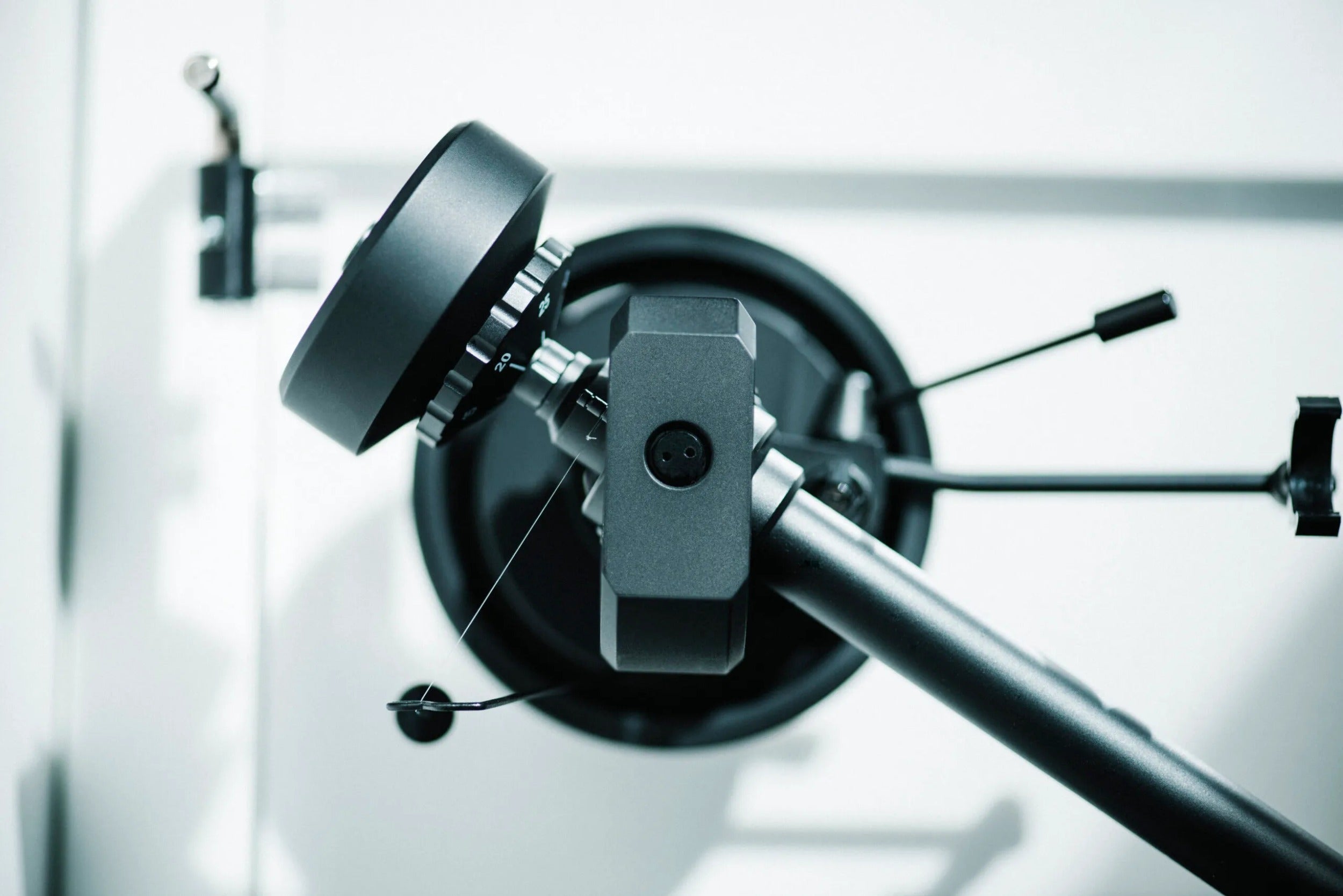 Pro-Ject XA B turntable setup with wooden tonearm and platter, showcasing its sleek design and high-quality audio components.