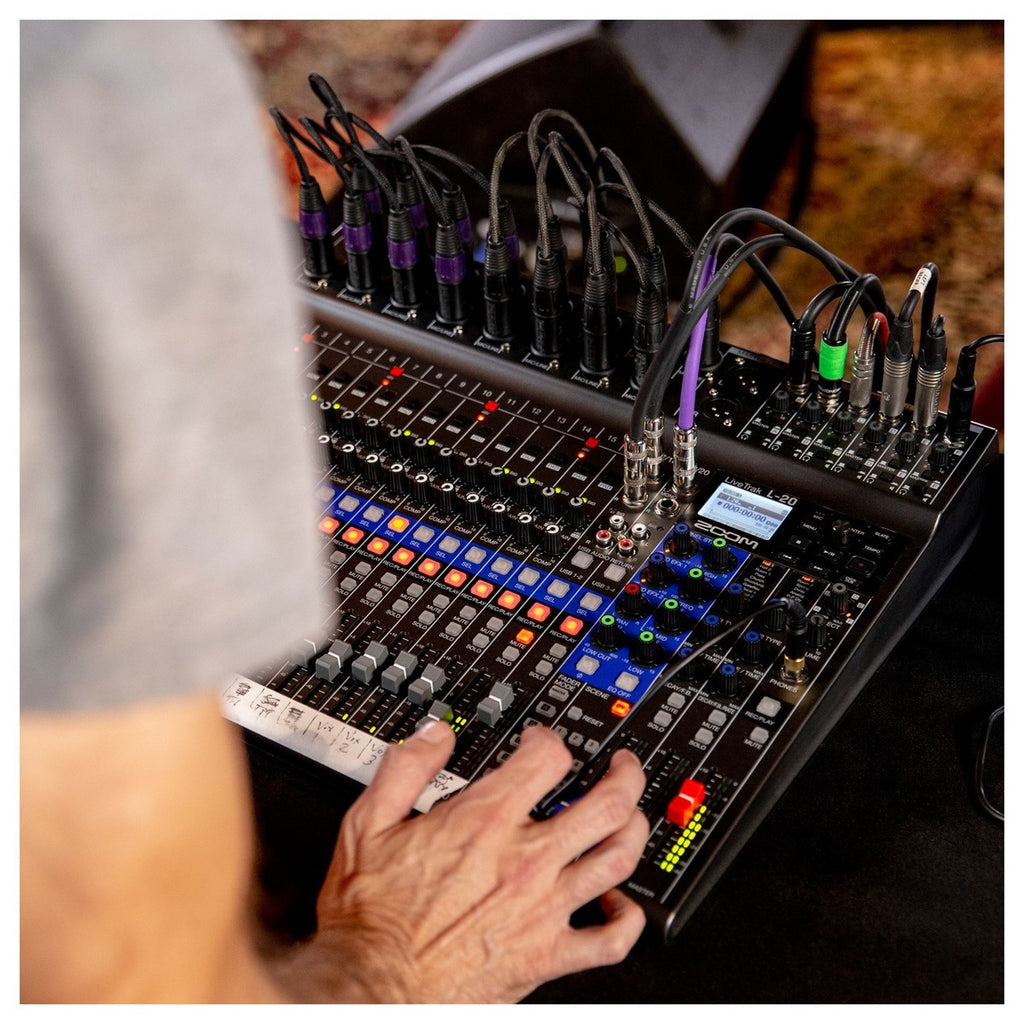 Zoom LiveTrak L-20 digital mixer with multiple faders and control knobs on a sleek black interface.